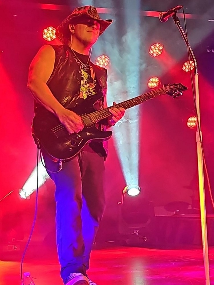 Mick Drybread playing guitar on stage